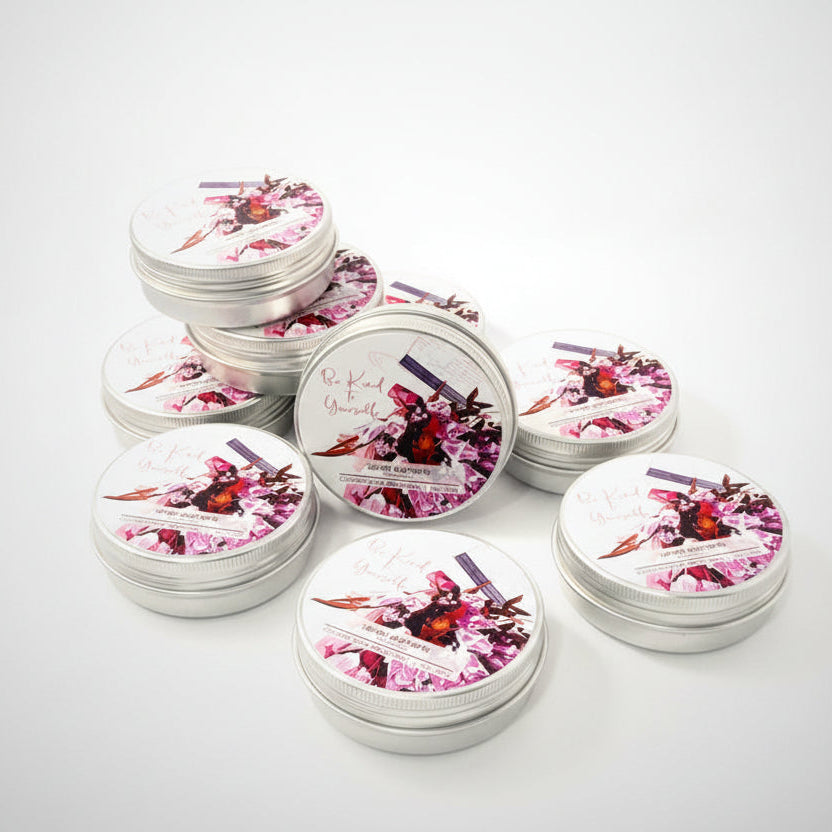 Multiple small candles with floral designs on lids arranged on a white surface