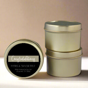 Gold cylindrical tins with a 'Congratulations' label on a beige background