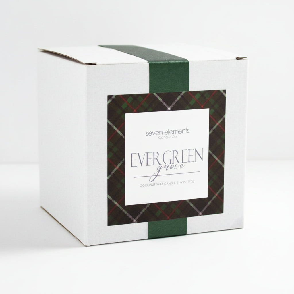 Candle box with plaid design and 'Evergreen Grove' label on a gray background