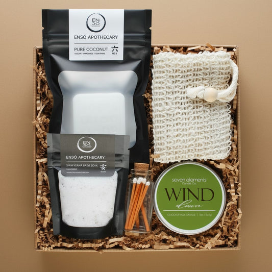 Gift set with Enso Apothecary products and a candle on a brown background